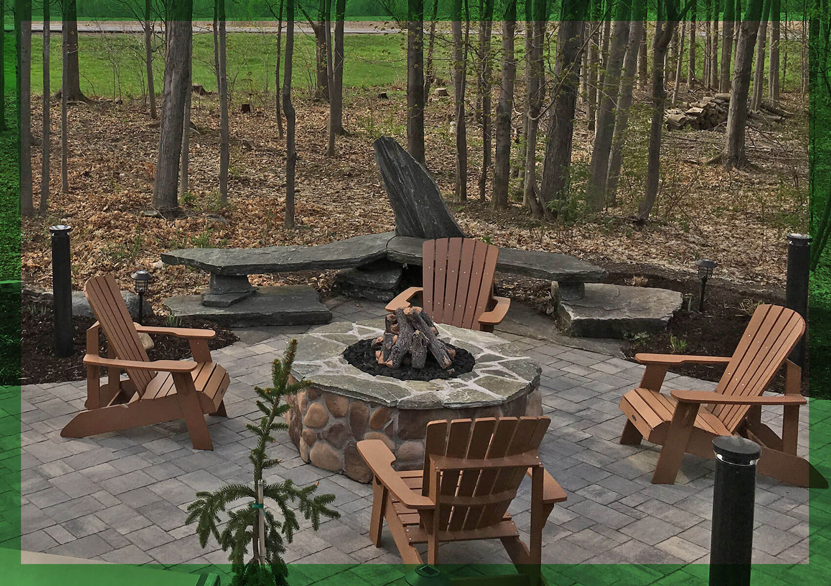 Adirondack chairs around an outdoor fireplace in Central New York